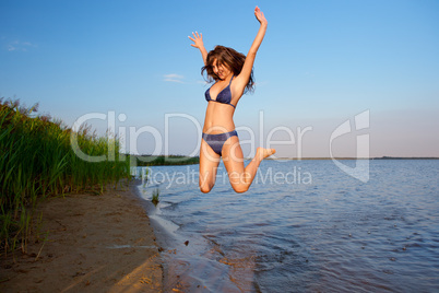 young woman on the sky and water background