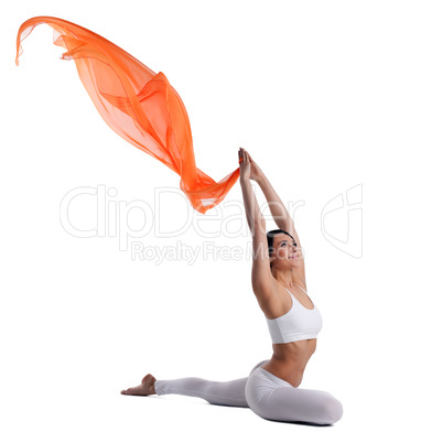 woman doing yoga pose and orange flying cloth