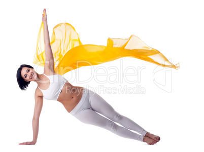 woman yoga stand on hand and yellow flying fabric