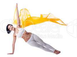 woman yoga stand on hand and yellow flying fabric