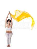 woman in yoga pose and yellow flying fabric