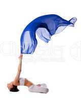 woman in lotos yoga pose with blue flying fabric