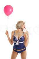 Beauty woman in lingerie with balloons lick candy