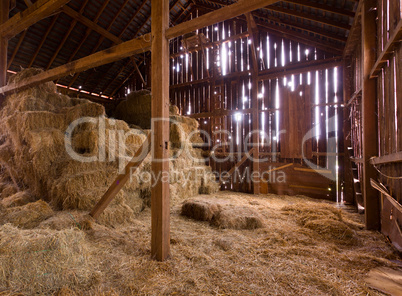 Interior of old barn with straw bales