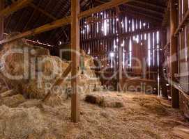 Interior of old barn with straw bales