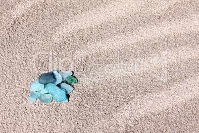 Glass pebbles on the sand