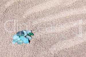Glass pebbles on the sand