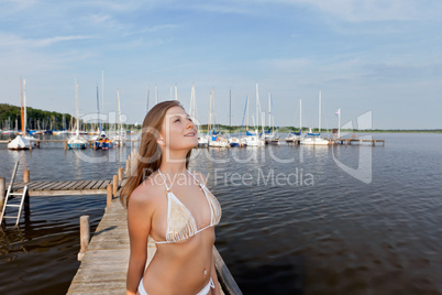 Attractive young woman near the yachts