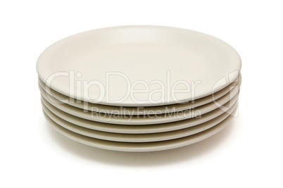 Stack of plain beige dinner plates isolated