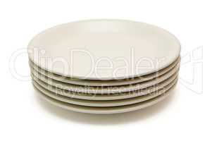 Stack of plain beige dinner plates isolated