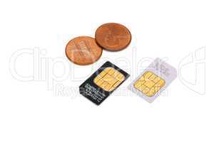 Two SIM cards for cellular phones and Americal cents isolated