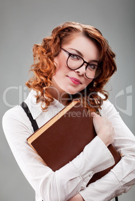 young woman in glasses with a book