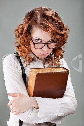 young woman in glasses with a book