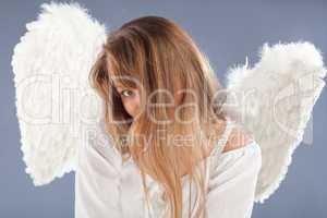 beautiful blonde angel against grey  background