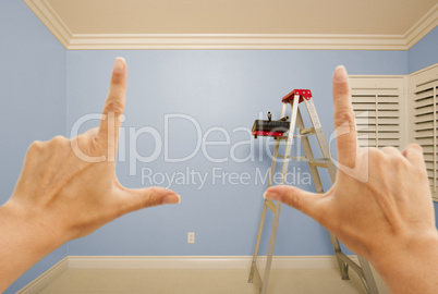 Hands Framing Blue Painted Wall Interior