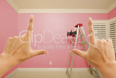 Hands Framing Pink Painted Wall Interior