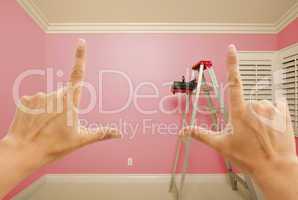 Hands Framing Pink Painted Wall Interior