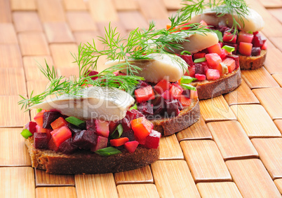 Sandwiches with rye bread, herring and vegetables