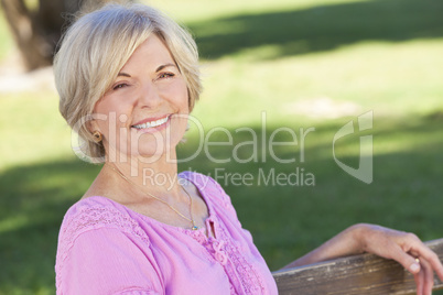 Happy Senior Woman Sitting Outside Smiling