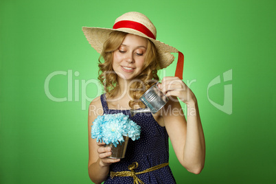 Attractive girl watering flowers