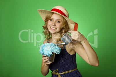 Attractive girl watering flowers