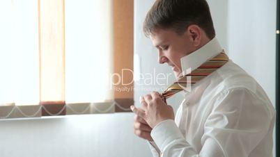 Man tying necktie