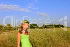 Teenage girl among grass