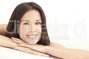 Happy Young Woman Resting on Hands in Spa Style Shot