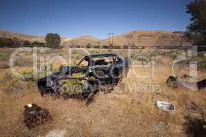 An old abandoned vintage delivery truck van in a field