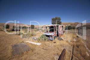 An old abandoned vintage delivery truck van in a field