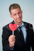 Young business man showing a heart