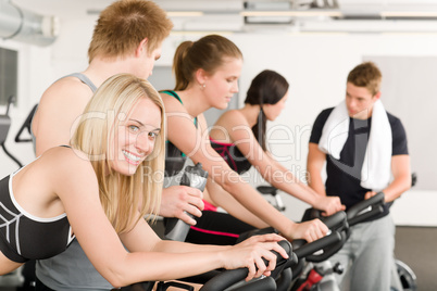 Fitness group of people on gym bike