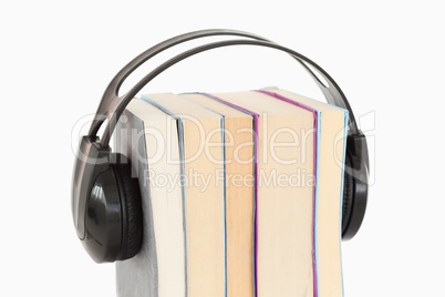 Close up of a stack of books and headphones