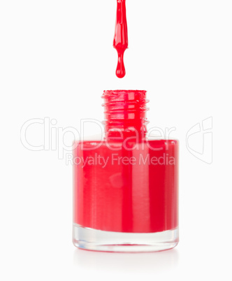 Portrait of a red nail polish droping in its flask