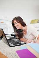 Young beautiful woman relaxing with her laptop and posing while