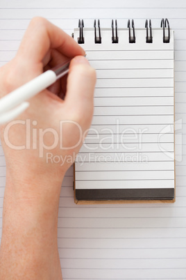 Woman hands writing on a notebook