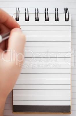 Woman hands writing on a notebook