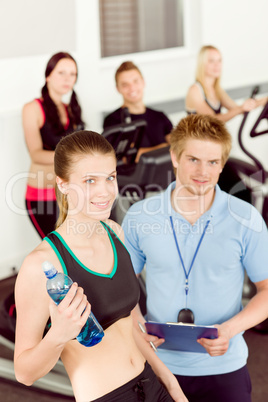 Young fitness woman doing spinning with instructor
