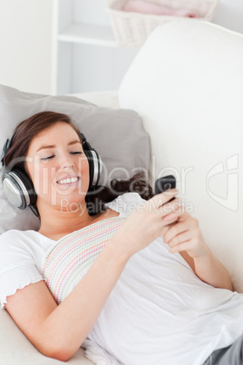 Charming brunette woman writing a text on her mobile