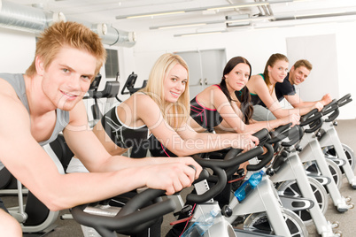 Fitness group of people on gym bike