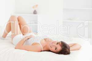 Gorgeous brunette woman posing while lying