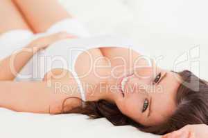 Gorgeous brunette female posing while lying