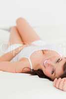 Attractive brunette female posing while lying