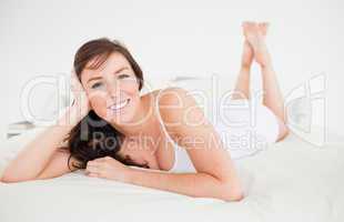 Good looking brunette female posing while lying