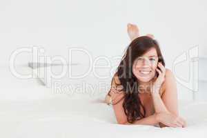 Pretty female on phone while lying