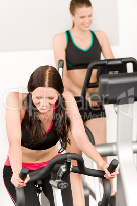 Fitness young girl on gym bike