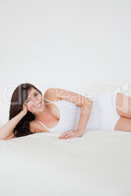 Beautiful brunette woman posing while lying Beautiful brunette woman posing while lying