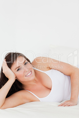 Good looking brunette woman posing while lying