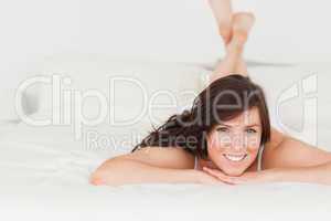 Good looking brunette female posing while lying