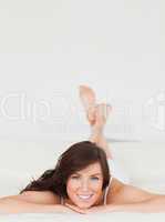 Attractive brunette female posing while lying